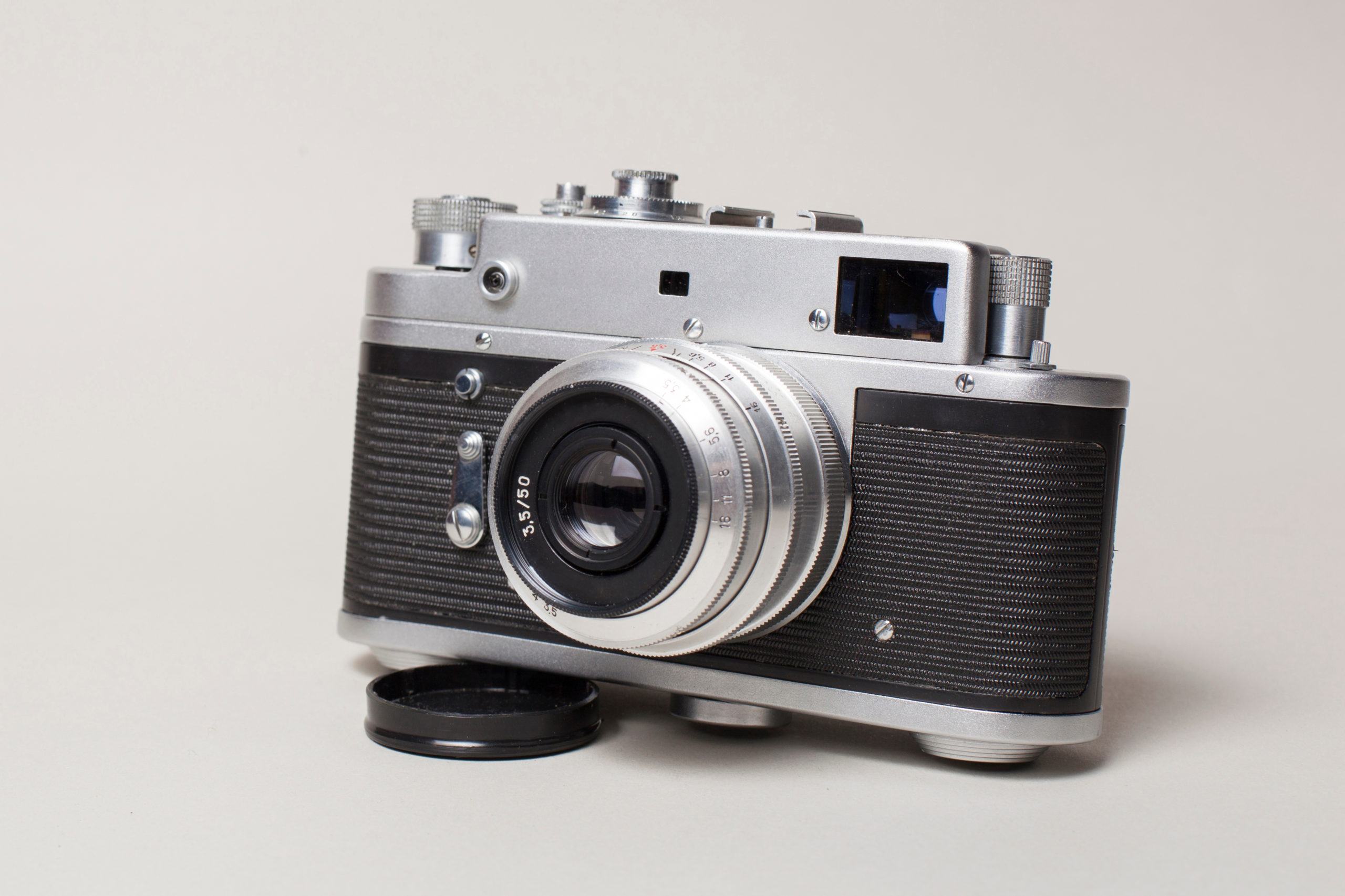 Vintage film camera on white table at Delray Camera & Studio Camera store Delray Beach